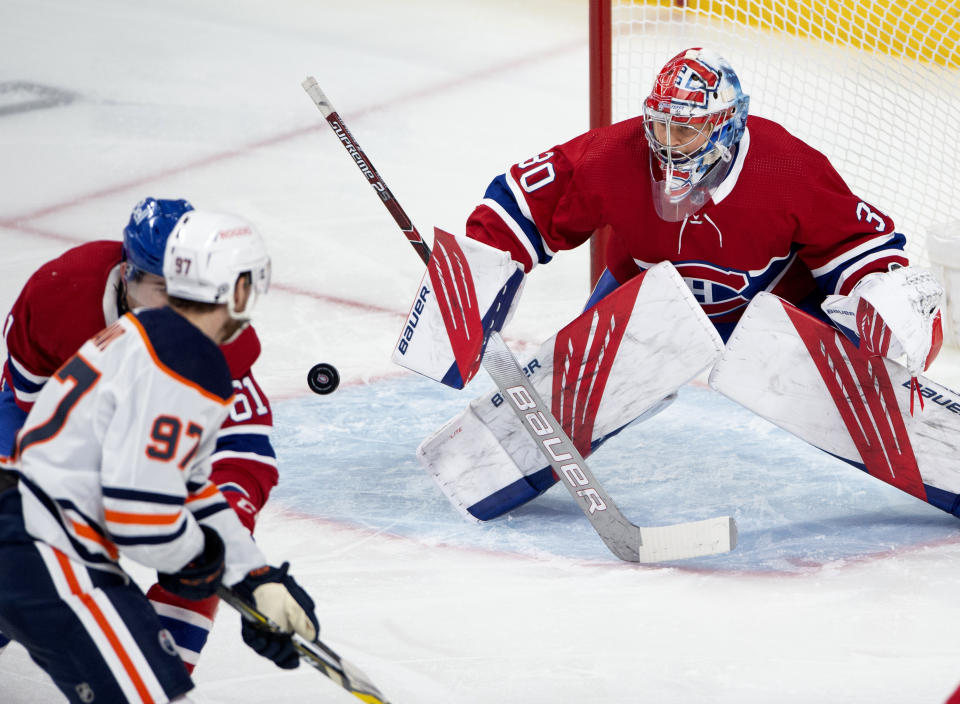 Montreal Canadiens goaltender Cayden Primeau (30) makes a save on Edmonton Oilers' Connor McDavid (97) during the first period of an NHL hockey game, Wednesday, May 12, 2021 in Montreal. (Ryan Remiorz/Canadian Press via AP)