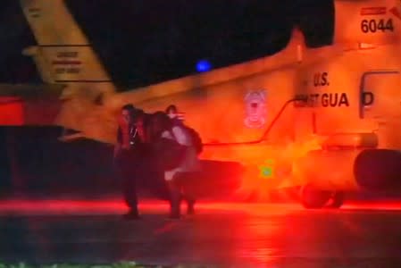 Injured people from a clinic in Great Abaco Island's Marsh Harbour arrive after being evacuated in a U.S. Coast Guard helicopter