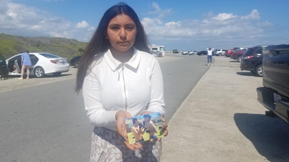 Kayla Hernandez shows pictures of her brother, David Hernandez. He went missing while swimming with friends at Fort Fisher.