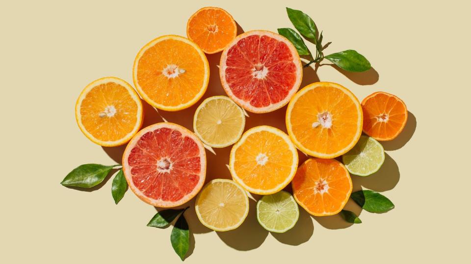 pattern of slices citrus fruit of lemons, oranges, grapefruit, lime on beige background healthy food, diet and detox concept flat lay, top view