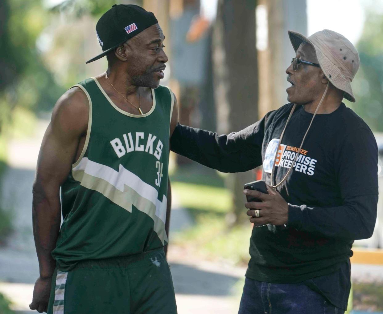 Terry Estes, left, and Promise Keeper Kenneth Peavey share a moment prior to Peavey and other Promise Keepers going door to door Sept. 17, asking residents to scan a QR code and take an eight-question survey regarding a new community center that is opening up along East Chambers Street and North Palmer Street in Milwaukee.