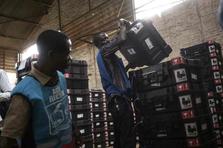 Independent National Election Commission (CENI) workers load a truck with voting materials for distribution to polling stations in Bukavu