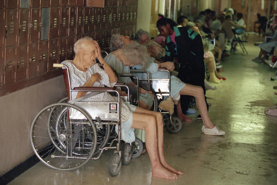 <p>Residents of a Homestead, Fla. nursing home line the halls of the Richmond Heights Middle School, Tuesday, Aug. 25, 1992, in Homestead, Fla. About 70 elderly residents were evacuated Monday, many lacking medicine. Officials said their former residence was wrecked by Hurricane Andrew. (AP Photo/Chris O’Meara) </p>