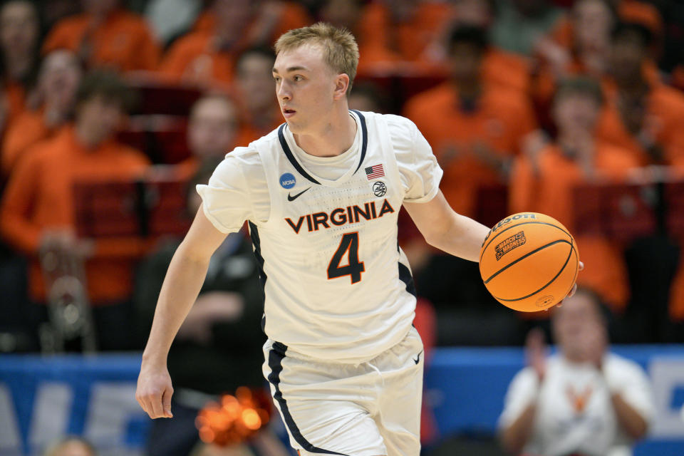 Virginia's Andrew Rohde controls the ball during the first half of a First Four college basketball game against Colorado State in the NCAA Tournament in Dayton, Ohio, Tuesday, March 19, 2024. (AP Photo/Jeff Dean)