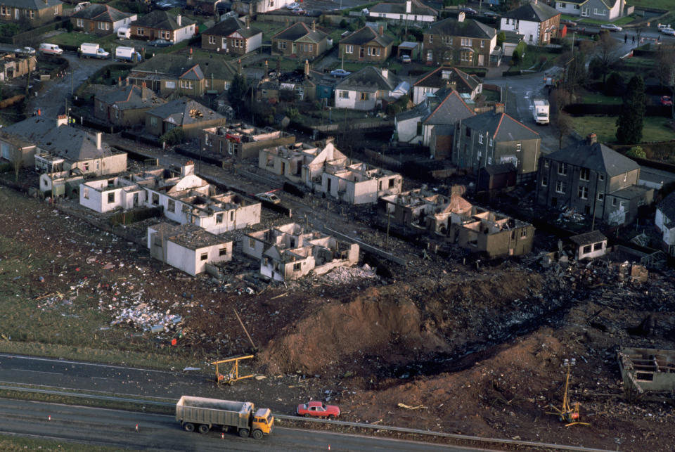 Aircraft debris and destroyed houses in Sherwood Crescent, Lockerbie are seen from the air as traffic passes along the A74 main road following the midair explosion of Pan Ams flight 103, 'Clipper Maid of the Seas over the village of Lockerbie, Dumfries and Galloway, United Kingdom, on Thursday, December 22, 1988. (Photo by Bryn Colton/Getty Images)