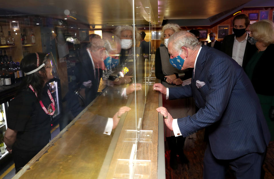 LONDON, ENGLAND - DECEMBER 03: Prince Charles, Prince of Wales wears a face mask as he speaks to bar staff during his visit to Soho Theatre with Camilla, Duchess of Cornwall to celebrate London's night economy on December 03, 2020 in London, England. (Photo by Chris Jackson - WPA Pool/Getty Images)