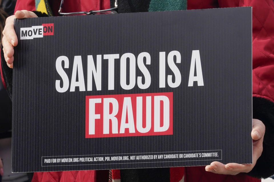 FILE - A constituent from the district of Rep. George Santos, R-N.Y., holds a sign during the news conference outside the U.S. Capitol calling on House Speaker Kevin McCarthy to expel Santos from Congress, on Capitol Hill Tuesday, Feb. 7, 2023, in Washington. Santos is carrying on in Congress despite calls for him to resign. Santos admitted to fabricating many aspects of his life story, but the newly elected congressman is refusing calls to quit. (AP Photo/Mariam Zuhaib, File)