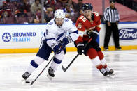 Tampa Bay Lightning center Tyler Johnson (9) skates with the puck as Florida Panthers center Noel Acciari (55) defends during the second period in Game 2 of an NHL hockey Stanley Cup first-round playoff series Tuesday, May 18, 2021, in Sunrise, Fla. (AP Photo/Lynne Sladky)