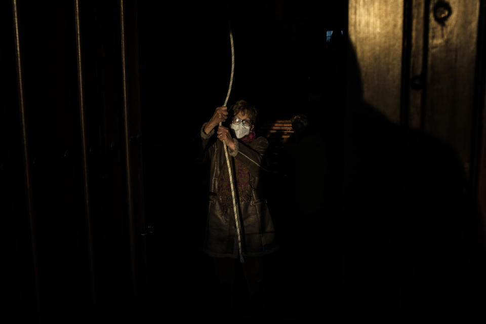 An elderly parishioner tolls the bell at the Catholic church of Cazurra, a village of around 75 inhabitants, in the Zamora province of Spain, Saturday, Nov. 27, 2021. According to the Sociological Research Center, a public institute, 62% of Spaniards define themselves as Catholics, down from 85% in 2000 and 98% in 1975. Only about one-third of those Catholics say they’re actively practicing the faith. (AP Photo/Manu Brabo)