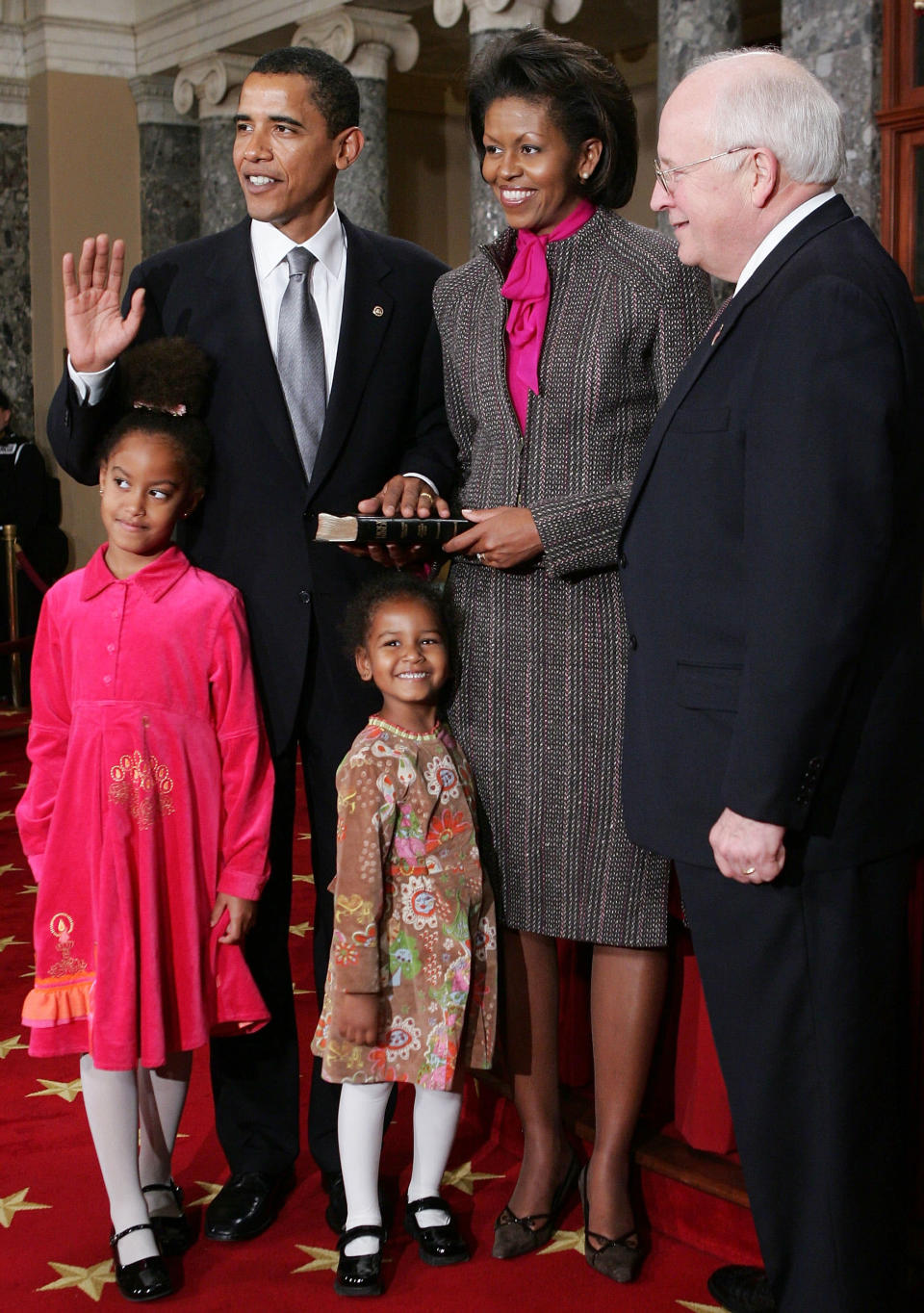 U.S. Senator Barack Obama (D-IL) (2nd L) poses for with his wife Michelle (2nd R), Vice President Dick Cheney (R), daughters (C) Malia and Sasha during the reenactment of a swearing -in ceremony on Capitol Hill January 4, 2005 in Washington, DC. The 109th Congress was sworn in January 4. (Photo by Alex Wong/Getty Images)