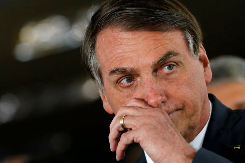 FILE PHOTO: Brazil's President Jair Bolsonaro gestures after a meeting with Brazil's Energy Minister Bento Albuquerque in Brasilia