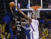 Oklahoma City Thunder forward Serge Ibaka (9) defends as Sacramento Kings guard Ben McLemore (16) shoots in the fourth quarter of an NBA basketball game in Oklahoma City, Sunday, Jan. 19, 2014. Oklahoma City won 108-93. (AP Photo/Sue Ogrocki)