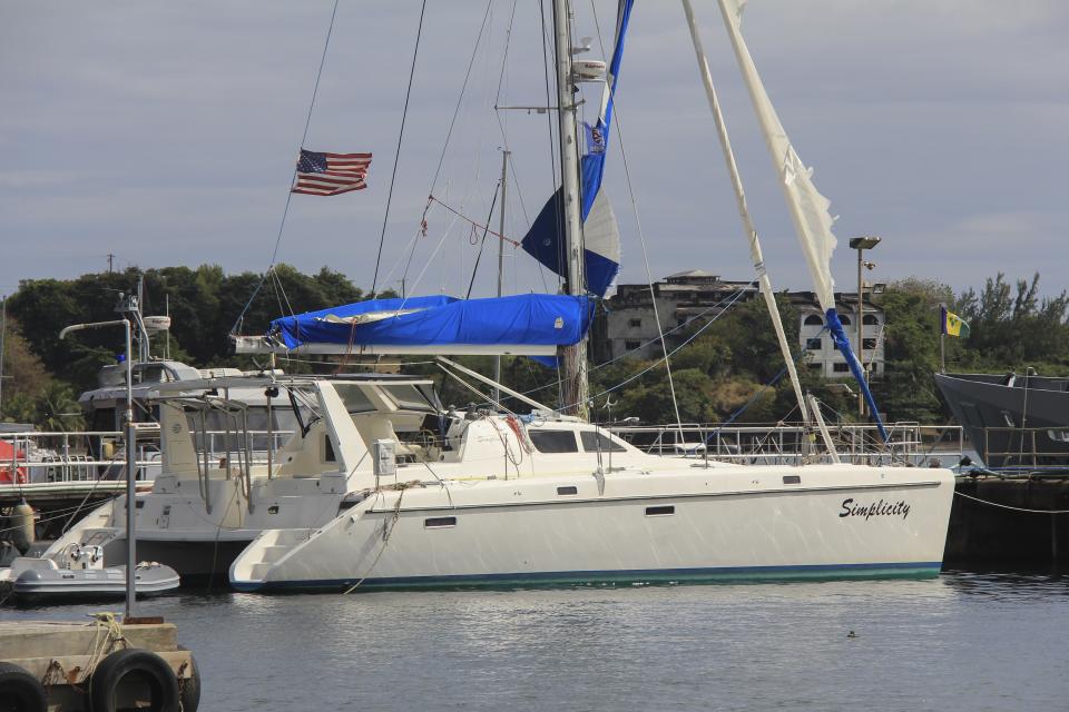 The yacht "Simplicity", that officials say was hijacked by three escaped prisoners with two people aboard, is docked at the St. Vincent and the Grenadines Coastguard Service Calliaqua Base, in Calliaqua, St. Vincent, Friday, Feb. 23, 2024. Authorities in the eastern Caribbean said they were trying to locate two people believed to be U.S. citizens who were aboard the yacht that was hijacked by the three escaped prisoners from Grenada. (AP Photo/Kenton X. Chance)