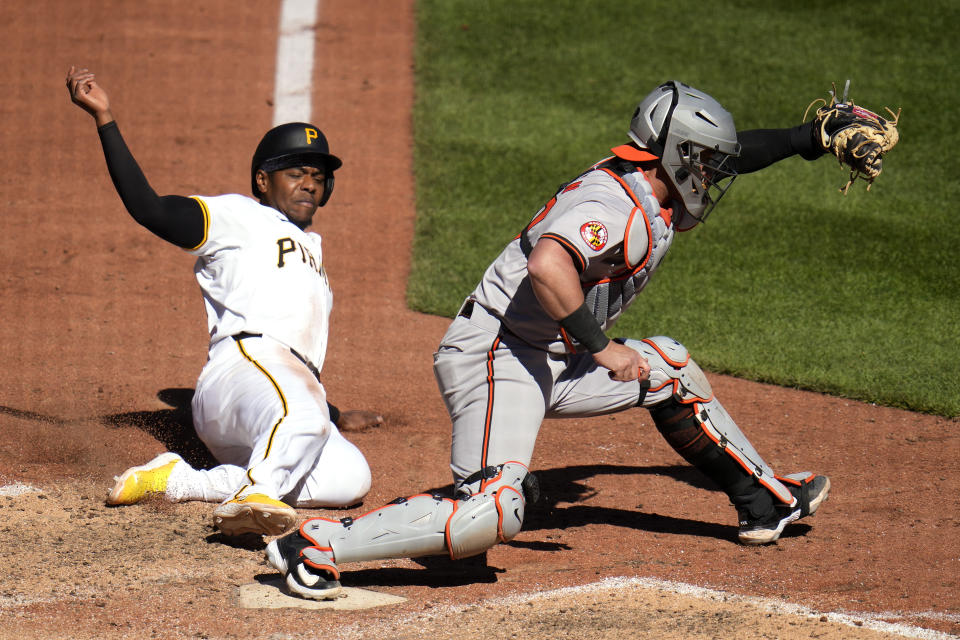 Pittsburgh Pirates' Ke'Bryan Hayes, left, is forced out at home by Baltimore Orioles catcher James McCann on a bases loaded fielder's choice by Rowdy Tellez during the bottom of the ninth inning of a baseball game in Pittsburgh, Sunday, April 7, 2024. The Pirates won 3-2. (AP Photo/Gene J. Puskar)