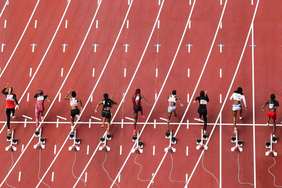 <p>TOPSHOT - Athletes compete in the women's 100m heats during the Tokyo 2020 Olympic Games at the Olympic Stadium in Tokyo on July 30, 2021. (Photo by Antonin THUILLIER / AFP) (Photo by ANTONIN THUILLIER/AFP via Getty Images)</p> 