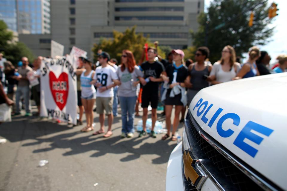 <p>Demonstrators are corralled by police outside the football stadium as the NFL’s Carolina Panthers host the Minnesota Vikings amid protesting of the police shooting of Keith Scott in Charlotte, North Carolina </p>