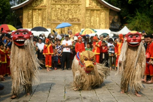 Performers dressed as sacred Lao ancestors and their lion cub dancing at the Wat Xiengthong Buddhist temple to mark the Laos New Year celebrations in Luang Prabang