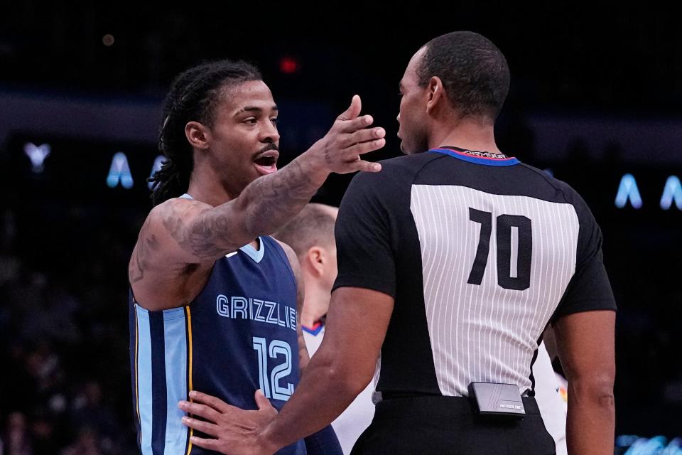 Memphis Grizzlies guard Ja Morant (12) talks to referee Phenizee Ransom, right, after receiving a technical foul in the first half of an NBA basketball game against the Oklahoma City Thunder, Saturday, Dec. 17, 2022, in Oklahoma City. (AP Photo/Sue Ogrocki)