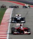 Ferrari Formula One driver Fernando Alonso of Spain (front) drives ahead of Williams Formula One driver Valtteri Bottas of Finland during the Austin F1 Grand Prix at the Circuit of the Americas in Austin November 17, 2013.