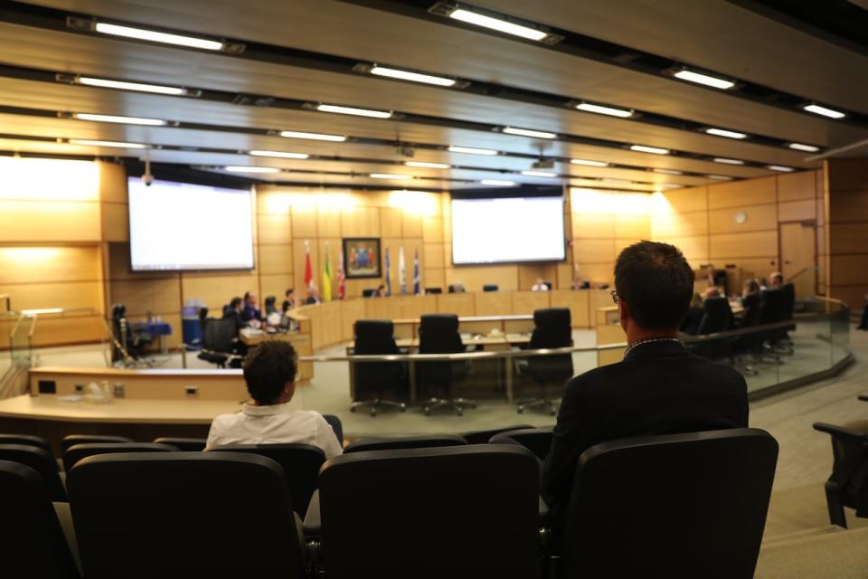 Councillors Dan LeBlanc and Andrew Stevens look as fellow members of Regina city council vote on a integrity commissioners report that found they breach council's code of conduct. 