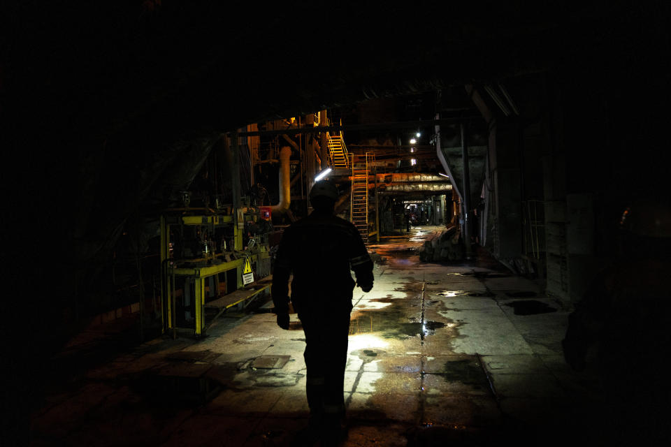 A worker walks along an internal corridor in a damaged DTEK thermal power plant after a Russian attack in Ukraine, Thursday, May 2, 2024. Ukrainian energy workers are struggling to repair the damage from intensifying airstrikes aimed at pulverizing Ukraine's energy grid, hobbling the economy and sapping the public's morale. (AP Photo/Francisco Seco)
