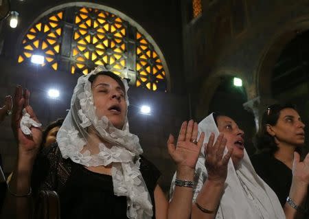 Relatives of the Christian victims of the crashed EgyptAir flight MS804 attend an absentee funeral mass at the main Cathedral in Cairo, Egypt, May 22, 2016. REUTERS/Mohamed Abd El Ghany