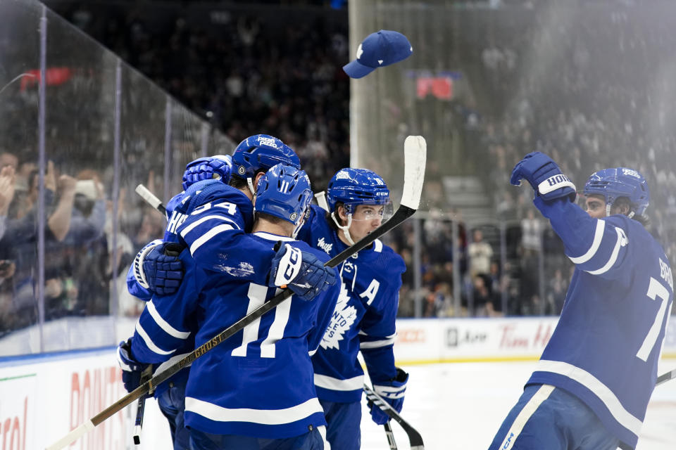 A fan throws a hat to celebrate the third goal by Toronto Maple Leafs center Auston Matthews against the Philadelphia Flyers, during the second period of an NHL hockey game Thursday, Feb. 15, 2024, in Toronto. (Arlyn McAdorey/The Canadian Press via AP)