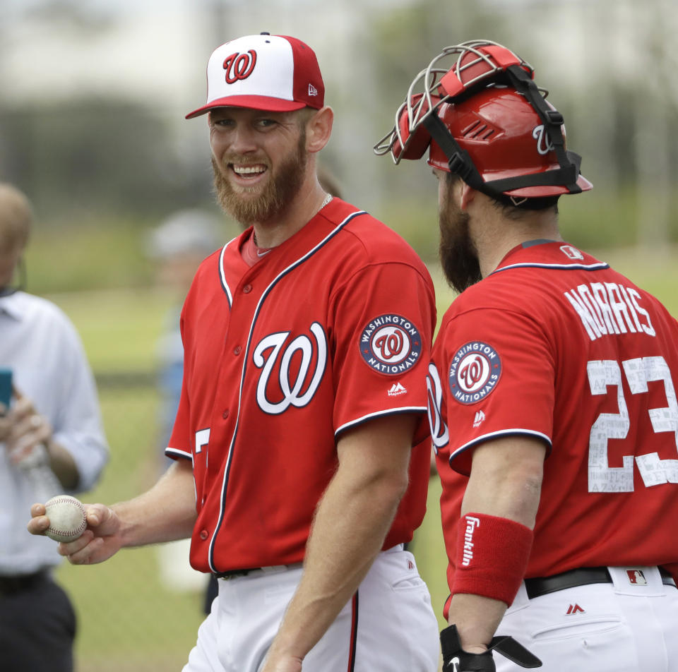 Washington Nationals pitcher Stephen Strasburg, left, talks with catcher Derek Norris (23) after throwing during a spring training baseball workout Thursday, Feb. 16, 2017, in West Palm Beach, Fla. (AP Photo/David J. Phillip)