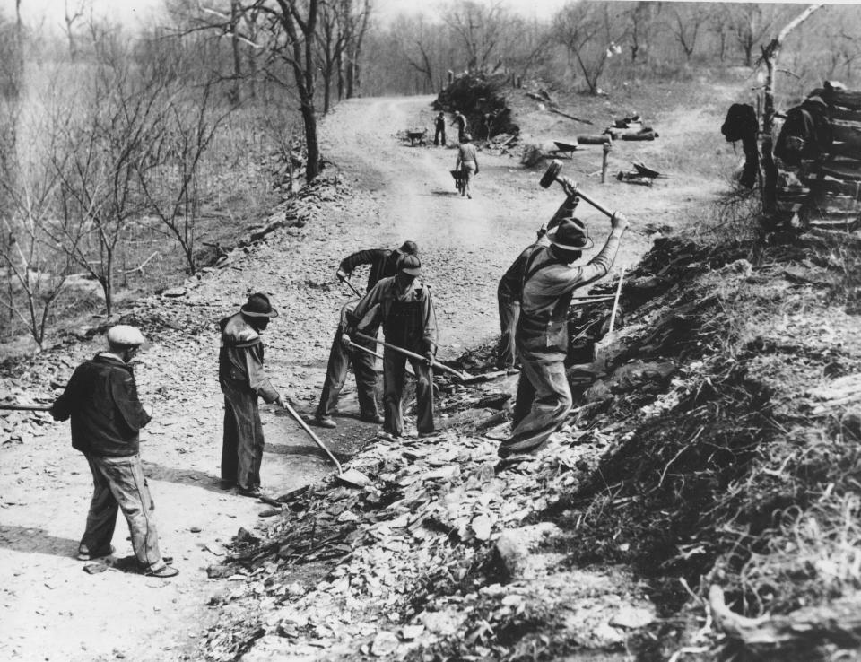 FILE - In this March 9, 1936, file photo Works Progress Administration (WPA) workers build a new farm-to-market road along Knob Creek in Tennessee. The New Deal was a try-anything moment during the Great Depression that remade the role of the federal government in American life. (AP Photo, File)