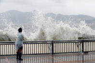 <p>A woman stands beside a big wave on a waterfront Typhoon Hato hitting in Hong Kong, China, Aug. 23, 2017. (Photo: Tyrone Siu/Reuters) </p>