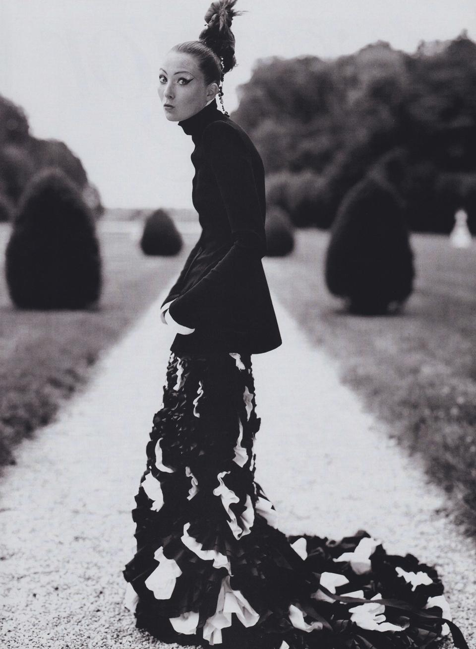 Maggie Rizer in a Chanel Haute Couture black wool jacket and dress with a black wool bodice and black-and-white silk taffeta skirt.