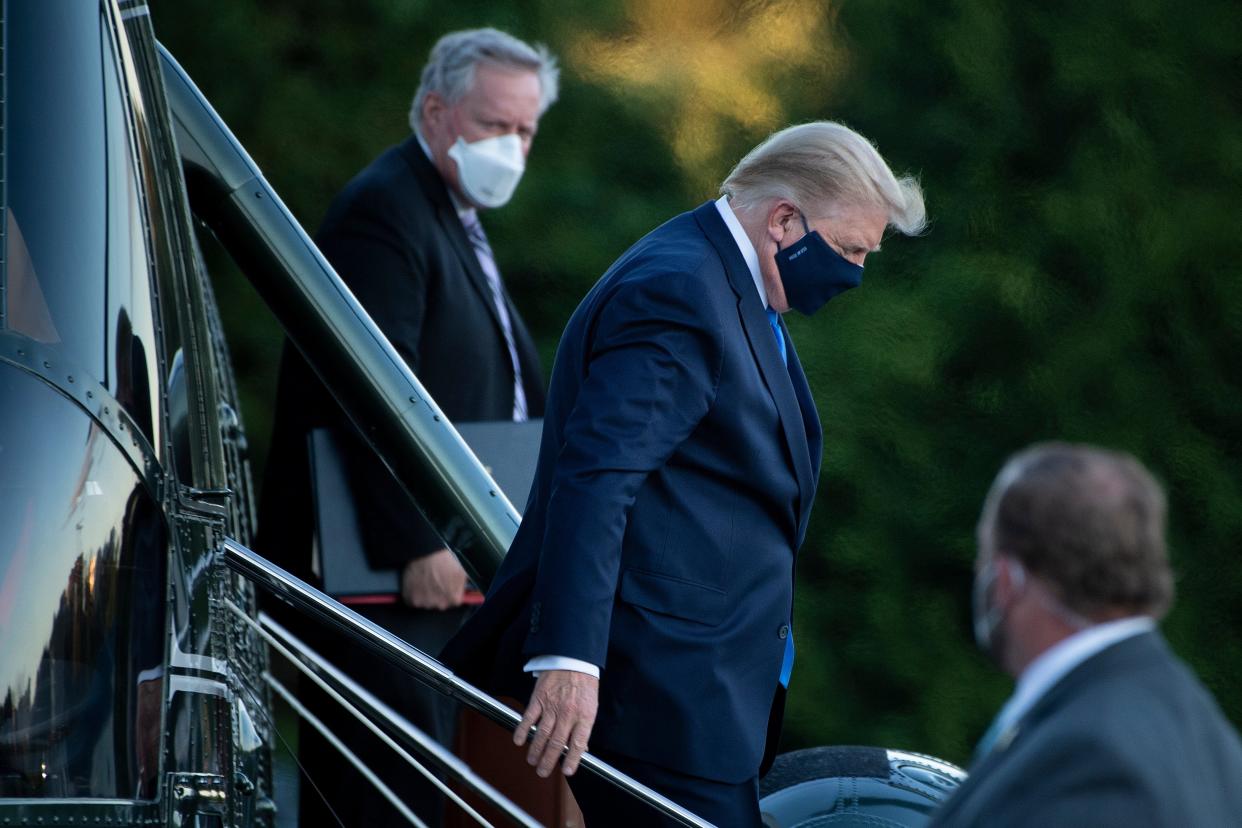 White House Chief of Staff Mark Meadows (L) watches as the then-US President Donald Trump (C) walks off Marine One while arriving at Walter Reed Medical Center in Bethesda, Maryland on 2 October  2020 (AFP via Getty Images)