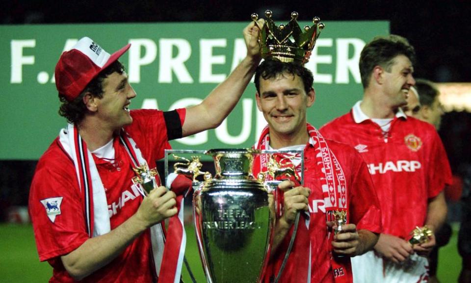 Steve Bruce crowns Bryan Robson after Manchester United win the Premier League in May 1993.