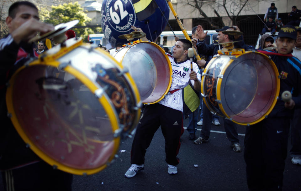 People bang drums as they attend a demonstration at Plaza de Mayo in Buenos Aires, Argentina, Wednesday, June 27, 2012. A strike and demonstration called by union leader Hugo Moyano demands steps that would effectively reduce taxes on low-income people, among other measures. (AP Photo/Natacha Pisarenko)