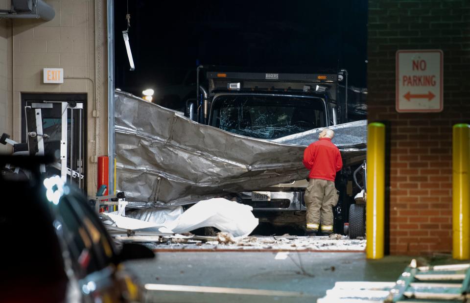 A man looks up at the damage done to the fire station after heavy storms hit the area in Springfield , Tenn., Saturday, Dec. 9, 2023.