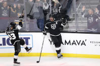 Los Angeles Kings forward Anze Kopitar, right, and Viktor Arvidsson celebrate Kopitar's third goal of the night against the Vegas Golden Knights, during the third period of an NHL hockey game Thursday, Oct. 14, 2021, in Los Angeles. The Kings won 6-2. (AP Photo/Ringo H.W. Chiu)