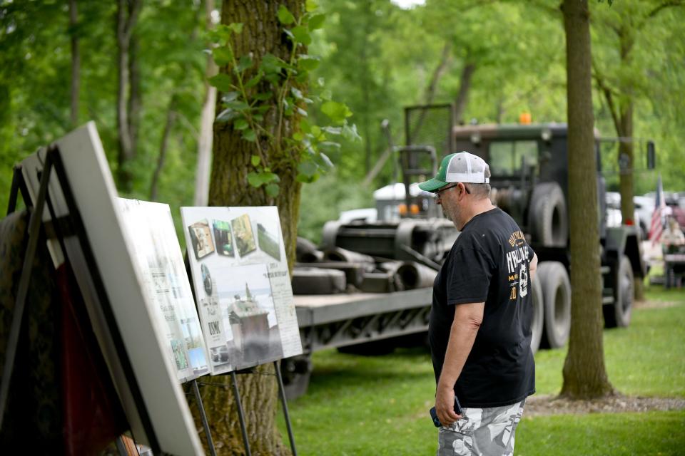 Bob LeHew of Kansas looks over a display at the Honor the Fallen event at Lost Trail Winery in Marlboro Township Saturday.