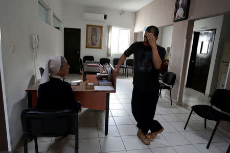 Mexican deportee Nico gestures while talking to sister Edith at Our Lady of Guadalupe migrant shelter in Reynosa, Mexico March 14, 2017. Picture taken March 14, 2017. REUTERS/Daniel Becerril