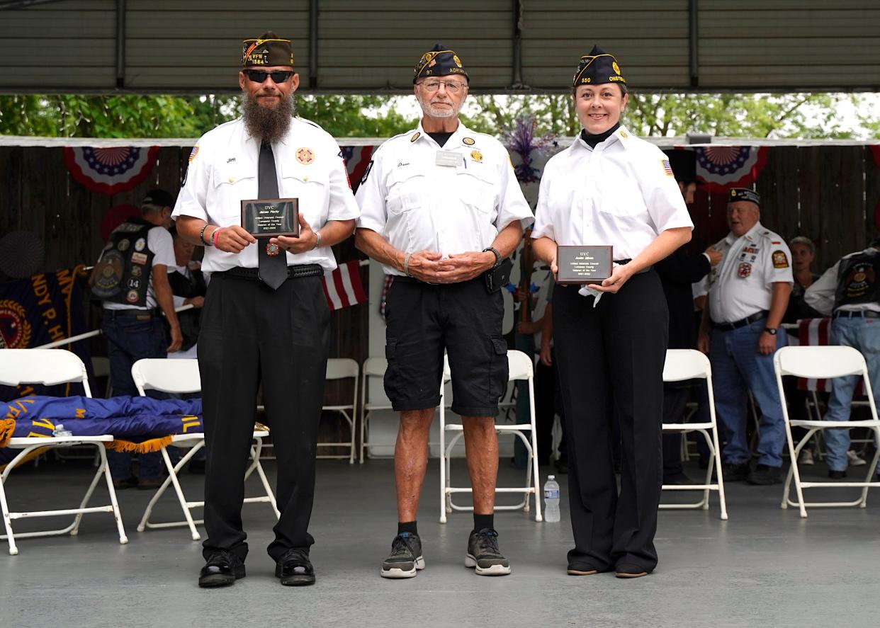 Jim Flarity, left, a 12-year Army veteran with 39 months deployed in Iraq and Afghanistan, and Audra Micon, right, who served in the United States Navy from 2000-04 and continued to serve as a military spouse, with her husband serving 20 years in the U.S. Navy, were both bestowed with the Veteran of the Year honor Wednesday at the Lenawee County Fair. Dave Loop, United Veterans Council Commander for Lenawee County and the master of ceremonies for the annual veterans program at the fair, stands in the center.