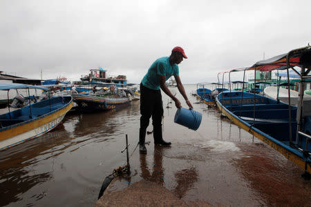 A indigenous man washes the floor at the Bluefields Port before the arrival of Storm Otto in Bluefields town, Nicaragua November 23,2016.REUTERS/Oswaldo Rivas