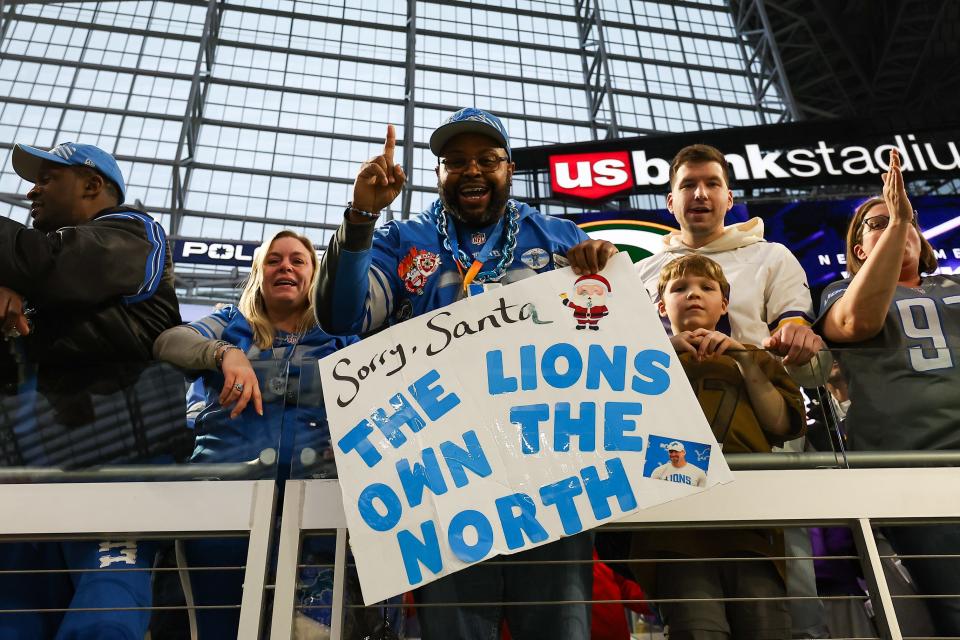 Detroit Lions fans celebrate the 30-24 win against the Minnesota Vikings to clinch the NFC North at U.S. Bank Stadium, Dec. 24, 2023, in Minneapolis.