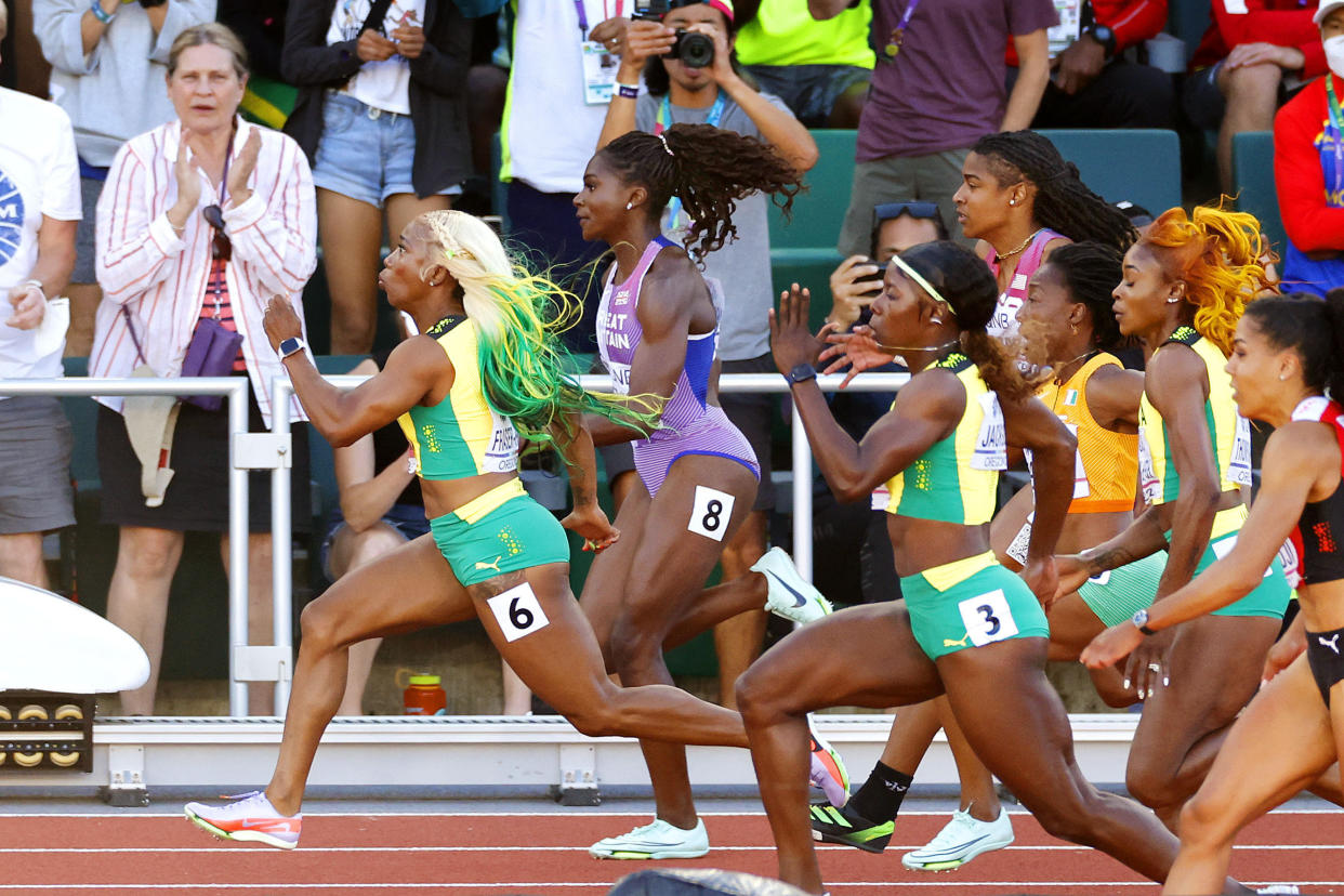 Shelly-Ann Fraser-Pryce (far L) of Jamaica, donning the iconic green and yellow, competes en route to winning the women's 100 meters final at the World Athletics Championships in Eugene, Oregon