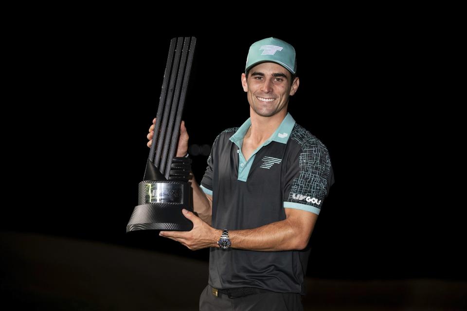 Captain Joaquín Niemann, of Torque GC, first place individual champion, celebrates with the trophy after winning in a four-hole playoff during the final round of LIV Golf Mayakoba at El Camaleón Golf Course, Sunday, Feb. 4, 2024, in Playa del Carmen, Mexico. (Montana Pritchard/LIV Golf via AP)