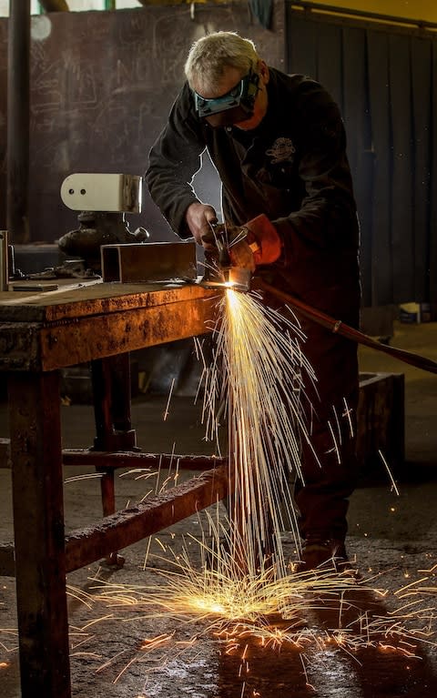 Gwyn Jones Boiler Maker, cutting steel - Credit: Charlotte Graham for The Telegraph