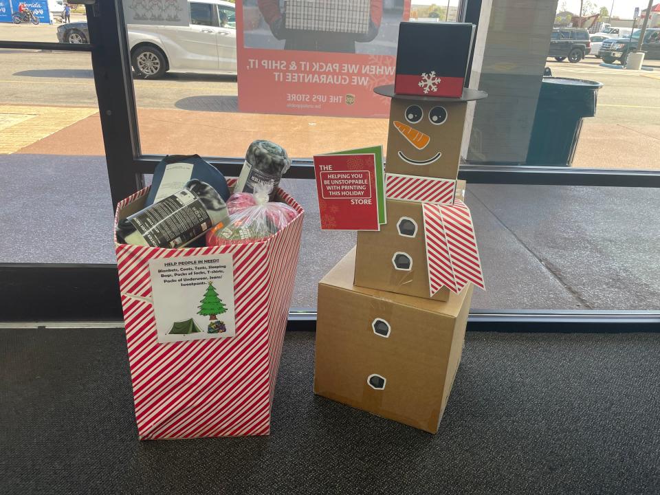 Items fill the drop boxes from the Project Helping Our Homeless and Hungry donation drive at the UPS Store on 23rd Street.