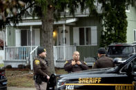 FILE - Three Oakland County Sheriff's deputies survey the grounds outside of the Crumbley residence while seeking James and Jennifer Crumbley, parents of Oxford High School shooter Ethan Crumbley, Dec. 3, 2021, in Oxford, Mich. A Detroit-area artist whose studio was where the parents of the Oxford High School student charged in a deadly shooting were found by police is cooperating with authorities and didn’t know the couple had stayed overnight, his attorney said Sunday, Dec, 5, 2021. (Jake May/The Flint Journal via AP)