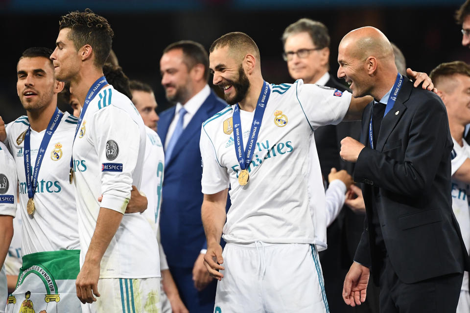 Real Madrid's French coach Zinedine Zidane (R), Real Madrid's French forward Karim Benzema (C) and Real Madrid's Portuguese forward Cristiano Ronaldo (L) celebrate after winning the UEFA Champions League final football match between Liverpool and Real Madrid at the Olympic Stadium in Kiev, Ukraine, on May 26, 2018. (Photo by FRANCK FIFE / AFP)        (Photo credit should read FRANCK FIFE/AFP via Getty Images)