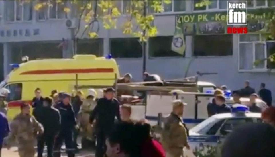 RETRANSMISSION TO CORRECT TO SHOOTING NOT EXPLOSION - In this image made from video, showing the scene as emergency services load an injured person onto a truck, in Kerch, Crimea, Wednesday Oct. 17, 2018. An 18-year-old student strode into his vocational school in Crimea, a hoodie covering his blond hair, then pulled out a shotgun and opened fire on Wednesday, killing 19 students and wounding more than 50 others before killing himself. (Kerch FM News via AP) KERCH.FM LOGO CANNOT BE OBSCURED