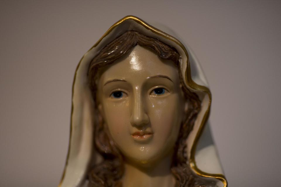 A statue of the Virgin Mary, that residents say "weeps" oil, has attracted thousands of visitors in the last week to an apartment belonging to the Khoury family, in Tarshiha, a small Israeli town near the Lebanon border,Tuesday, Feb. 11, 2014. The family says it is most striking when a "tear" seems to roll down the statue's cheek. Parts of the statue appear to be slick with moisture, even after it is wiped off. (AP Photo/Ariel Schalit)