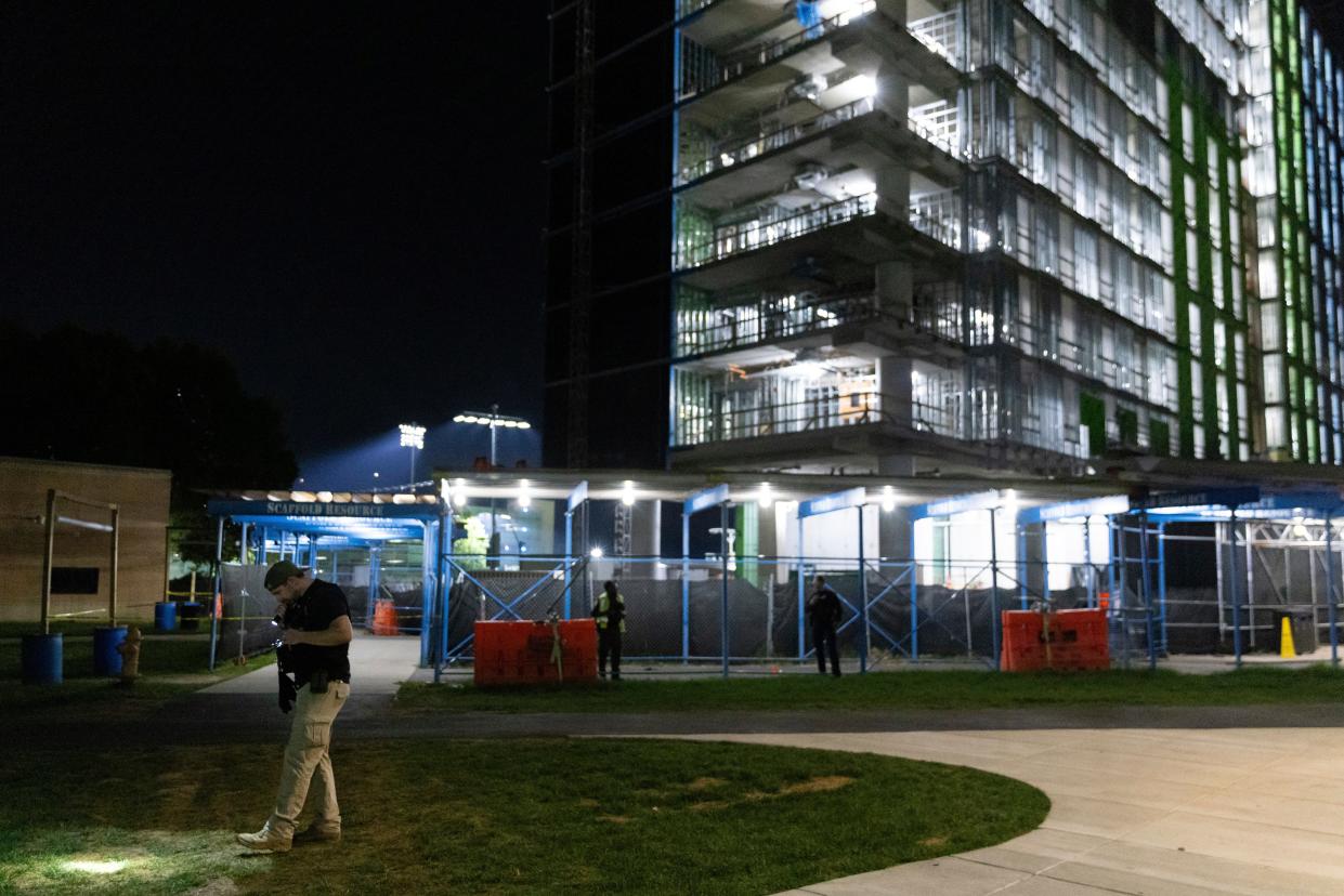 An ATF officer searches for evidence in front of a building at Morgan State University after a shooting, Wednesday, Oct. 4, 2023, in Baltimore (AP)